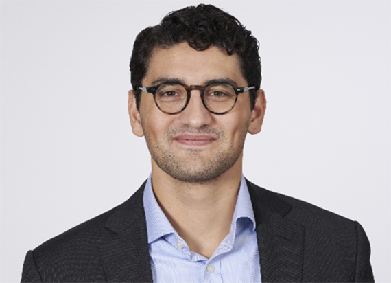 A headshot of Patrick Chang smiling on a white background